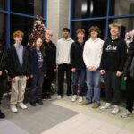 Members of Chelmsford High School's National Honor Society pose among the many donated items to be raffled off during the group's inaugural Festival of Trees.