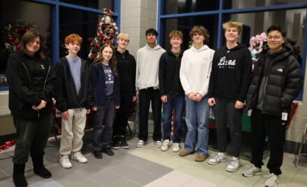 Members of Chelmsford High School's National Honor Society pose among the many donated items to be raffled off during the group's inaugural Festival of Trees.