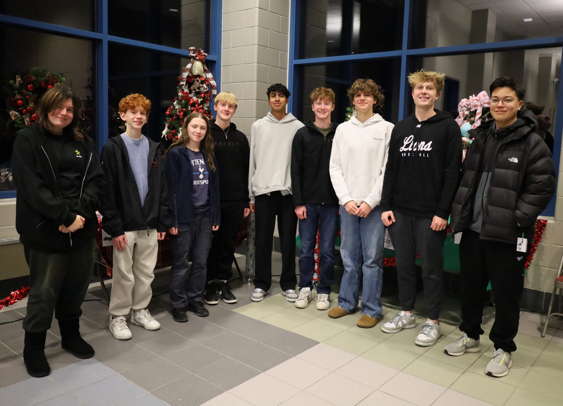 IMG_8827 Members of Chelmsford High School's National Honor Society pose among the many donated items to be raffled off during the group's inaugural Festival of Trees.