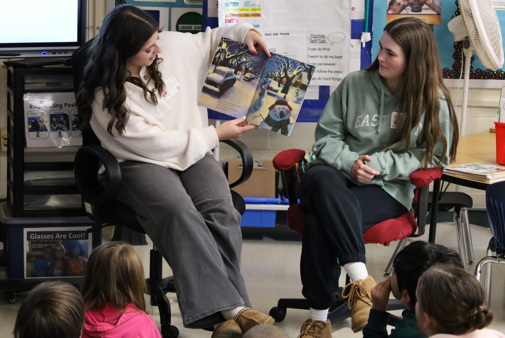 IMG_8828 Chelmsford High School National English Honor Society members Ellen Griswold and Maeve Chalmers read to students in Mrs. Bullock's first grade class at South Row Elementary School.
