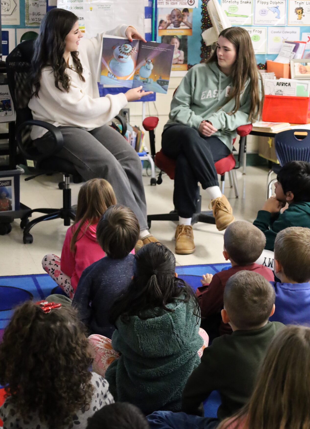 IMG_8829 Chelmsford High School National English Honor Society members Ellen Griswold and Maeve Chalmers read to students in Mrs. Bullock's first grade class at South Row Elementary School.