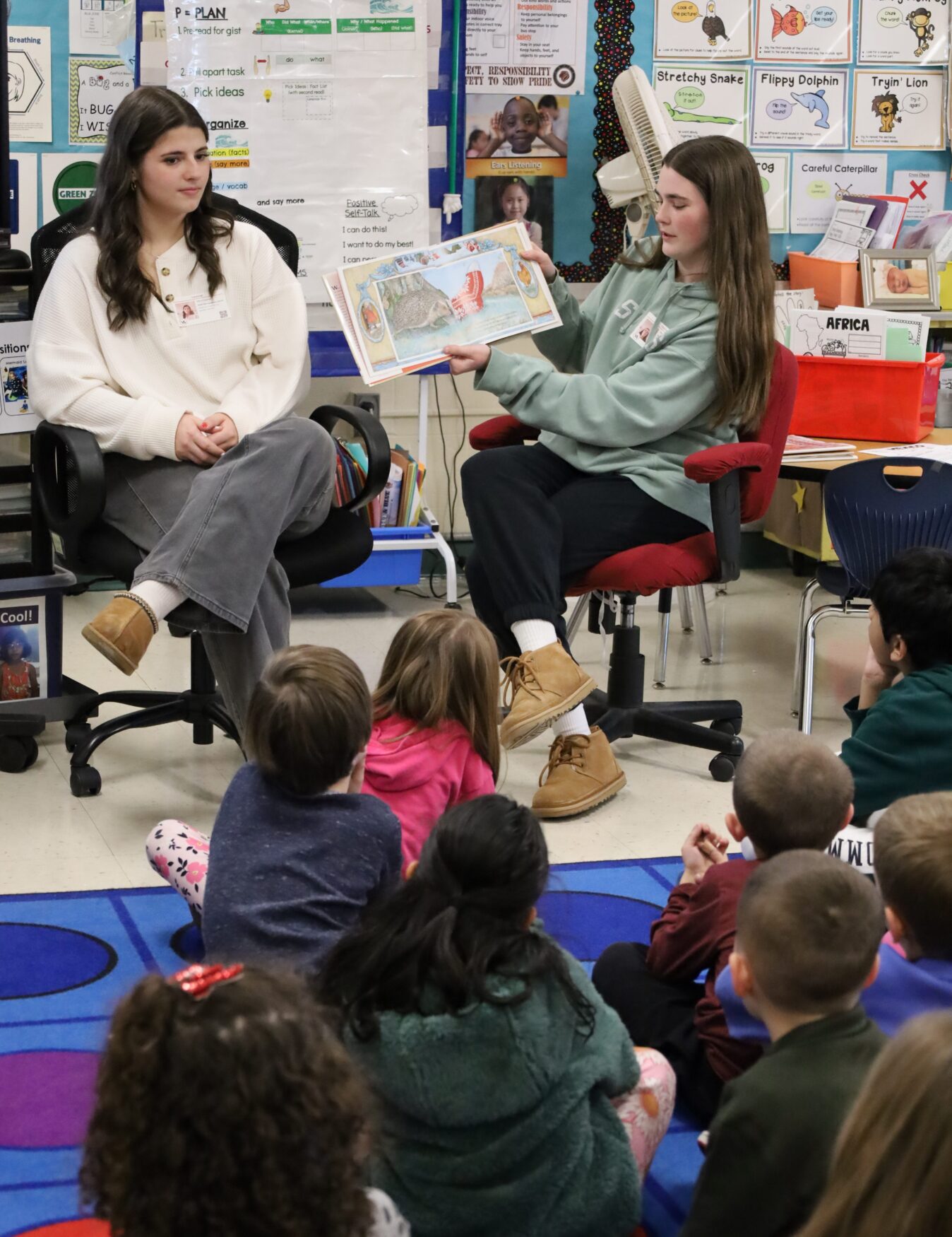IMG_8835 Chelmsford High School National English Honor Society members Ellen Griswold and Maeve Chalmers read to students in Mrs. Bullock's first grade class at South Row Elementary School.