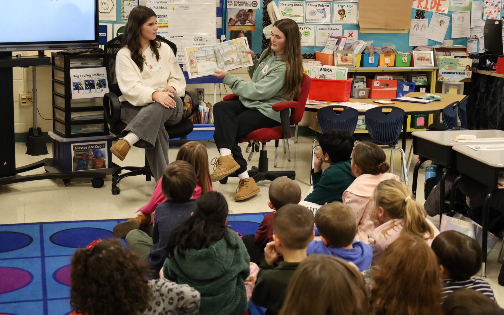IMG_8840 Chelmsford High School National English Honor Society members Ellen Griswold and Maeve Chalmers read to students in Mrs. Bullock's first grade class at South Row Elementary School.