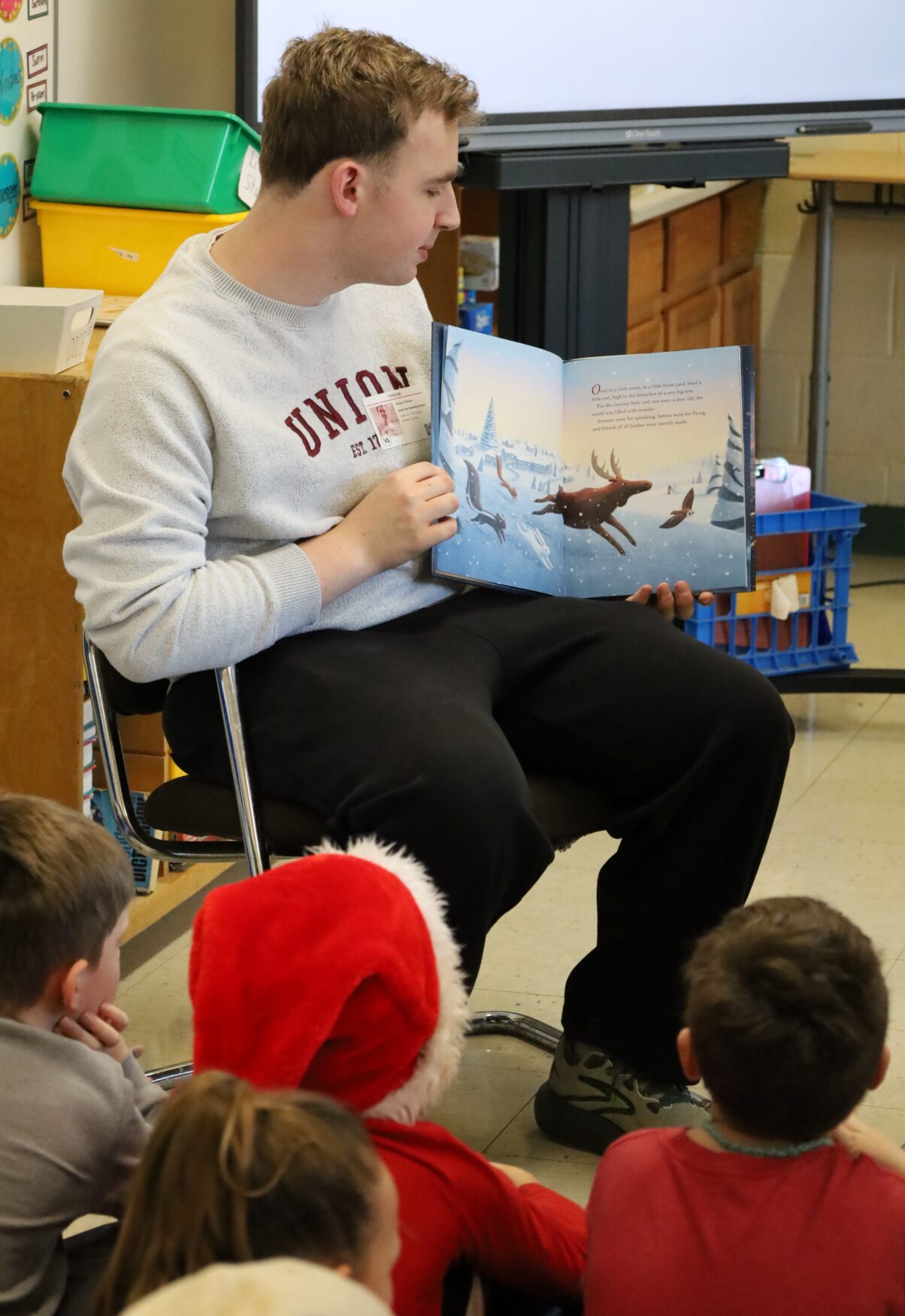 IMG_8848 Chelmsford High School National English Honor Society member Josh Wolman reads to students in Mrs. Stagnone's third grade class at South Row Elementary School.