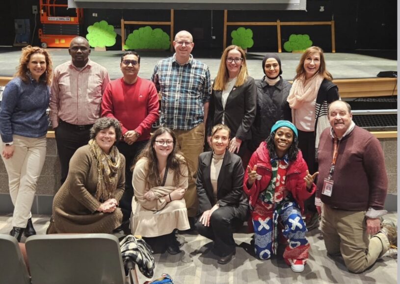 The 2026 Fulbright Teaching Excellence and Achievement (TEA) Fellows and their co-teachers pose for a photo in the Carl J. Rondina Performing Arts Center at Chelmsford High School.