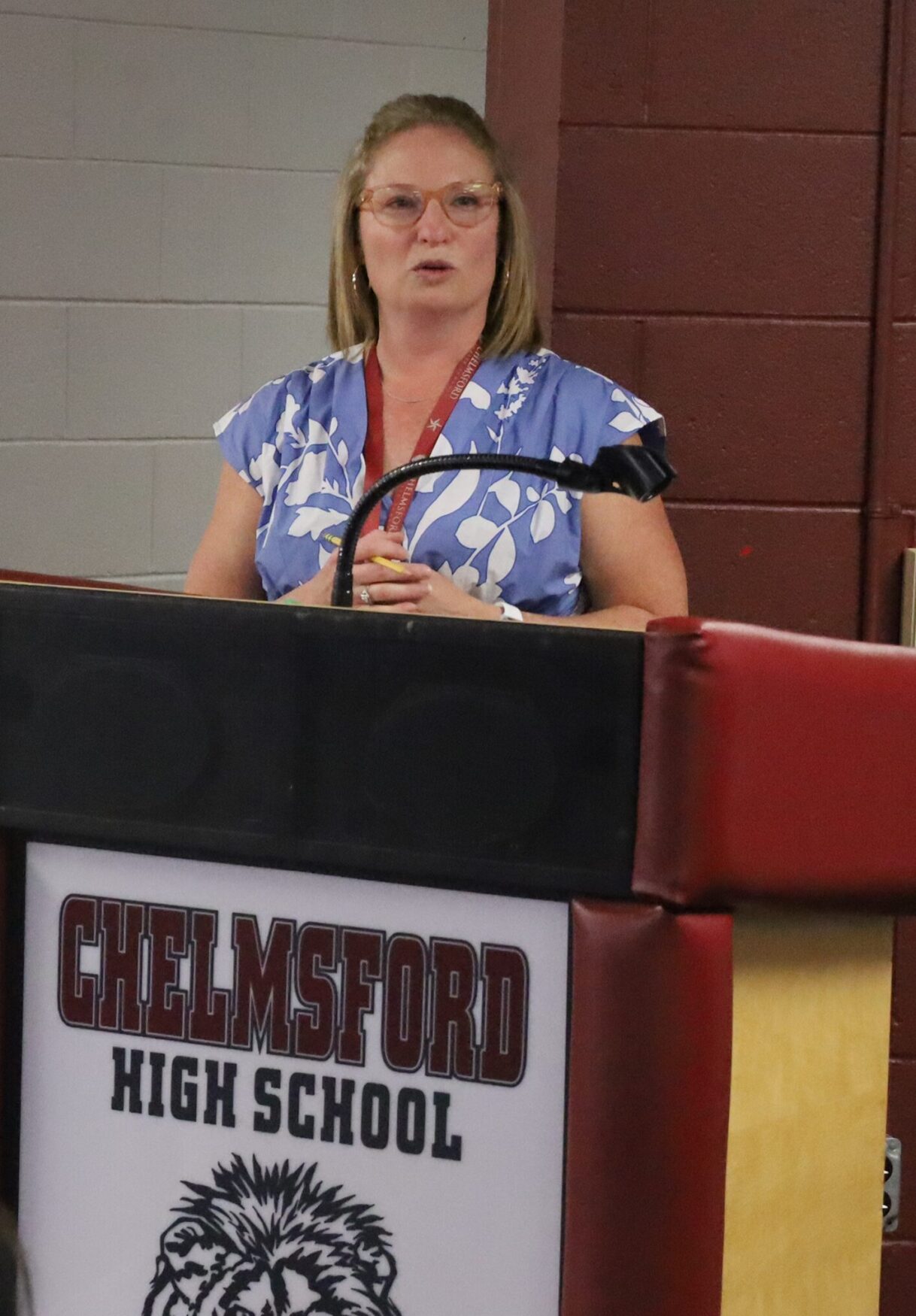 Katie Simes, the Health, Physical Education & Family and Consumer Sciences department coordinator for Chelmsford Public Schools, shares some opening remarks during the Future Teachers Signing Day ceremony on May 22, 2026.