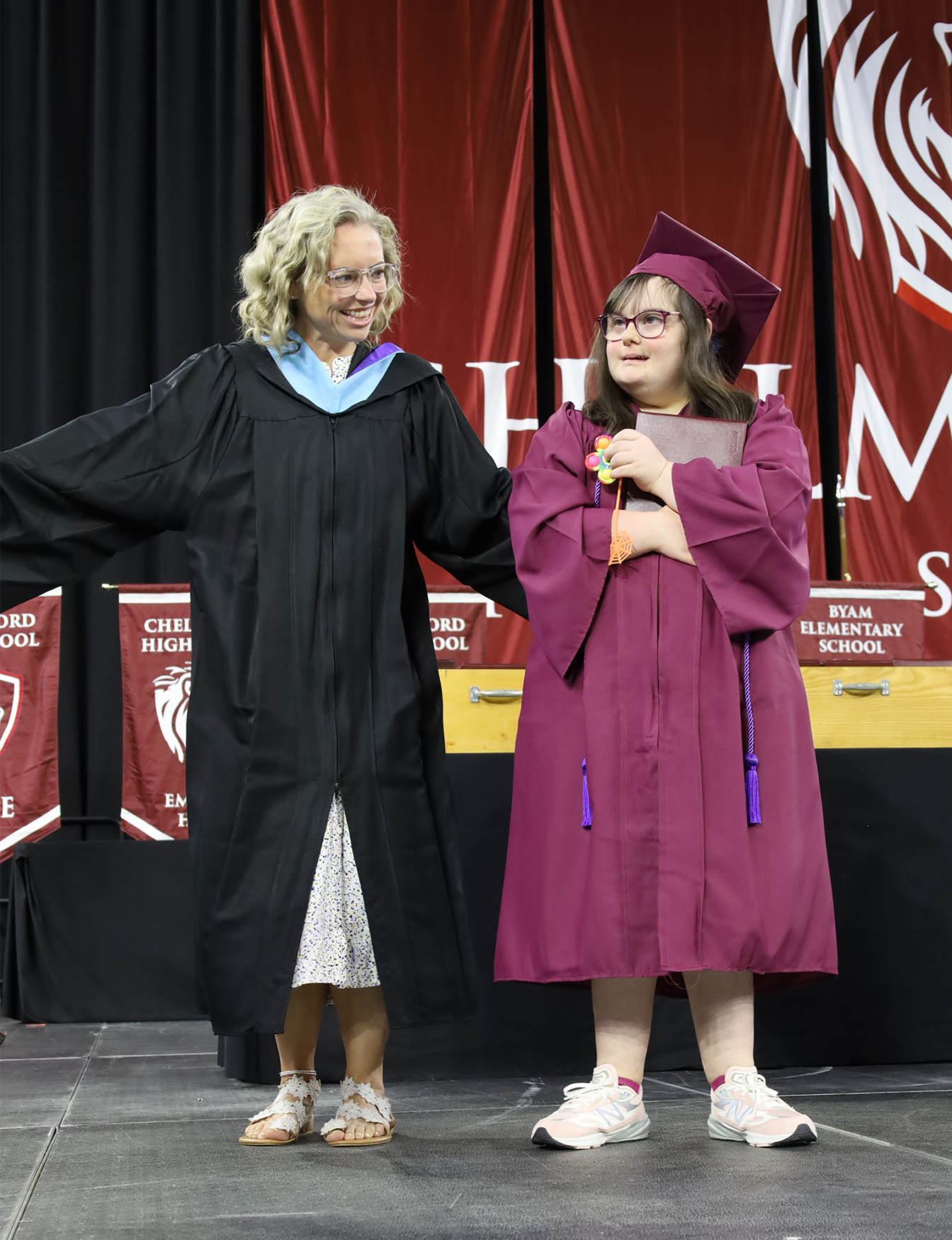 Erin Emma Grad Emerson Dean Erin MacNeil stands with the first graduate of Chelmsford High School's Class of 2026 to receive her diploma, Emma Auger.