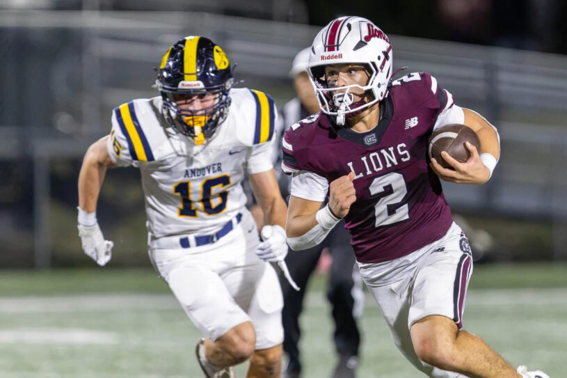 Chelmsford quarterback Skyler DeJesus gets past Andover’s Adrian Penney to pick up a first down during Friday’s MVC football game at Simonian Stadium in Chelmsford.