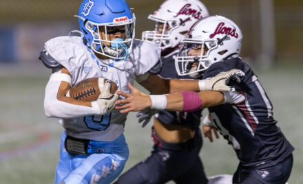 Dracut’s Phillip Dinh carries for a short gain before being tackled by Chelmsford defenders Aidan O’Donnell and Josh Valdez during Thursday’s MVC football game at Simonian Field in Chelmsford. Chelmsford captured a 25-0 win.