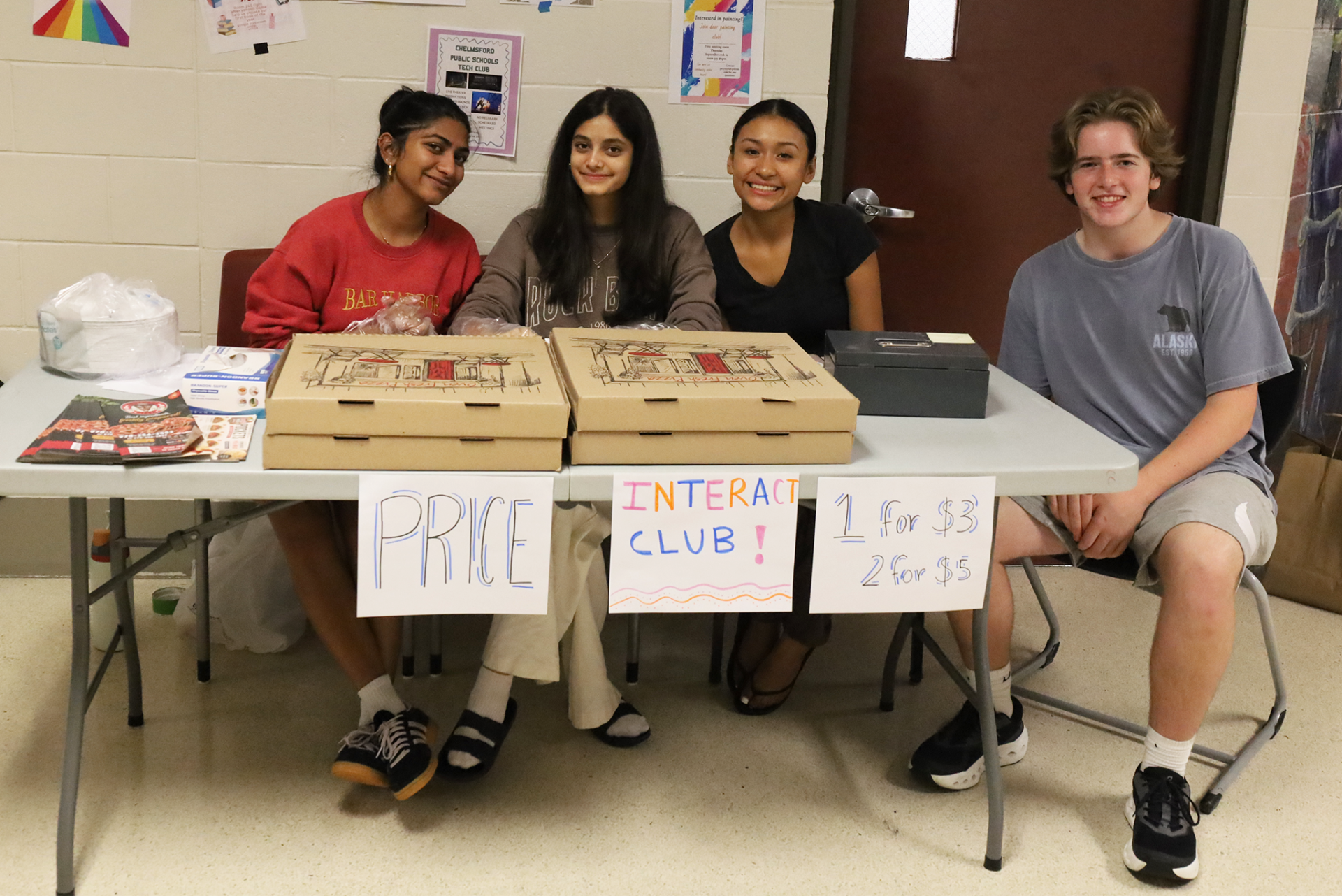 Members of Chelmsford High School's Interact Club sell slices of pizza during the parent-curriculum night open house on Thursday, Sept. 17, 2026.